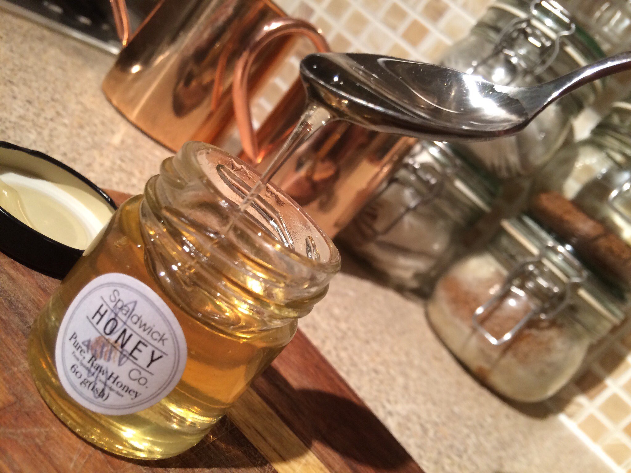 Pure Raw Honey from Cambridgeshire oozing off a spoon